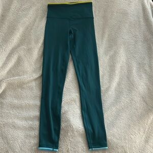 cotopaxi RARE leggings with yellow waist and blue ankles